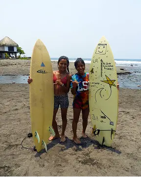 Young surfers holding their boards on the beach in La Libertad