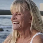 Sherry Correl smiling by the ocean in El Salvador